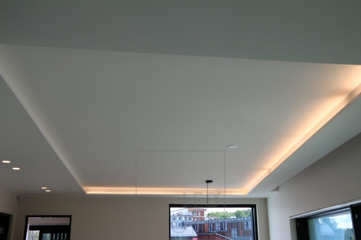 LED strip mounted on the lip, indirectly illuminating the space through the ceiling, creating mood lighting.
